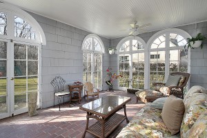 Sunroom in luxury home with view to back yard